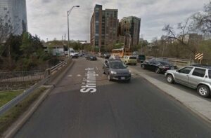 Road with cars parked beside and a building