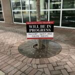 Black and Red Sign board Will be in Progress