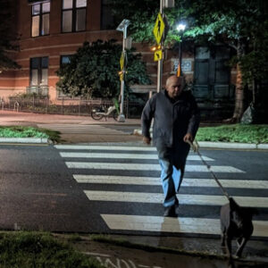 Man and dog in Shirlington Crosswalk at Night
